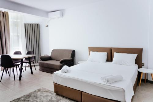 a bedroom with a bed and a table and chairs at Alezzi Beach Resort in Mamaia Nord