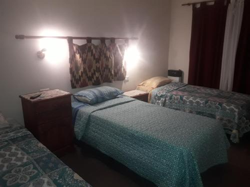 a hotel room with two beds at Departamentos del centro in Villa Mercedes