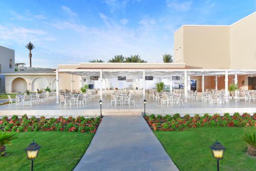 a courtyard with tables and chairs in a building at Jaz Mirabel Resort in Sharm El Sheikh