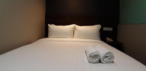 Ένα ή περισσότερα κρεβάτια σε δωμάτιο στο MIICO Hotel @ Mount Austin