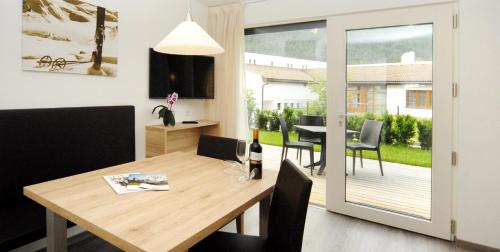 a dining room and living room with a table and chairs at Appartment Charly in Siusi