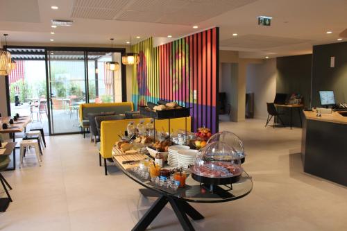 a table with food on it in a restaurant at Hôtel la Capelle Millau in Millau