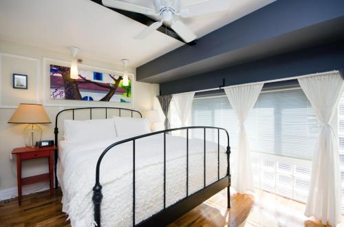 a bedroom with a bed and a large window at The Box House Hotel in Brooklyn
