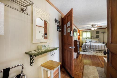 a hallway with a door and a bedroom with a bed at Hocking Hills Inn in Logan