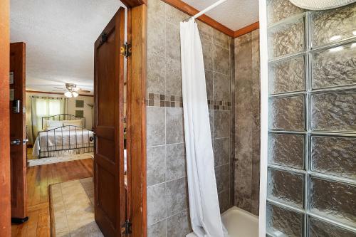 a bathroom with a shower and a glass door at Hocking Hills Inn in Logan
