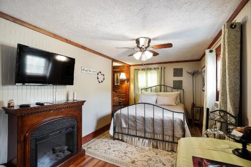 a bedroom with a bed and a fireplace and a television at Hocking Hills Inn in Logan