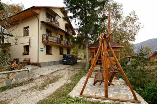 a house and a playground in front of a house at Hovanka in Yaremche