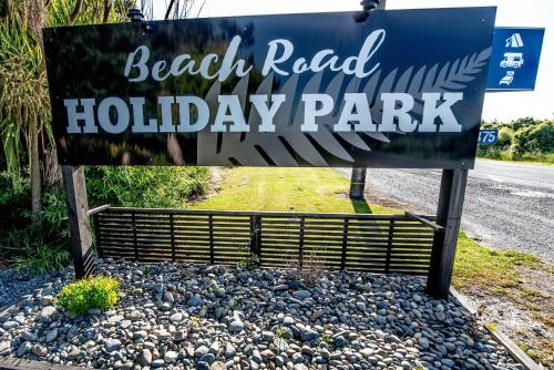 a sign for the beach road holiday park at beach road holiday park in Otatara