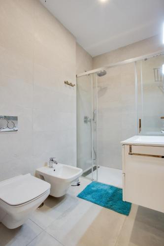 a bathroom with a toilet and a sink and a shower at ICEBERG LUXURY TARIFA Free Parking in Tarifa