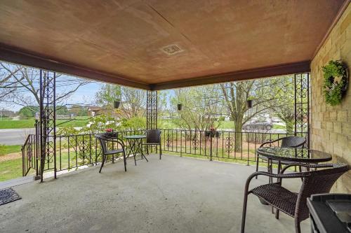 a patio with tables and chairs on a balcony at Hocking Hills Inn in Logan