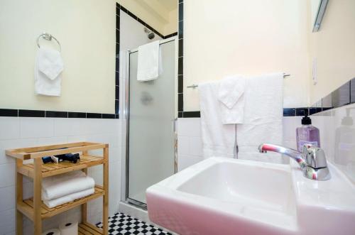a bathroom with a sink and a shower at The Box House Hotel in Brooklyn