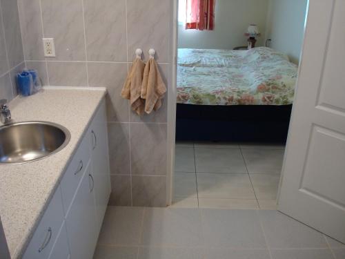 a bathroom with a sink and a bed in a room at Surinat Luxury Resort in Domburg