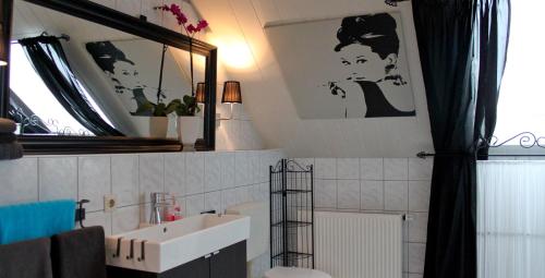 a bathroom with a sink and a mirror at Gästehaus Gebauer in Hornbach