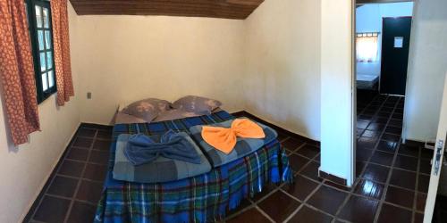 una camera con un letto con farfallini sopra di Pousada Soyndara a São Thomé das Letras