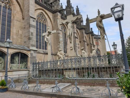 a church with a statue in front of a building at Villa Ferialis in Xanten