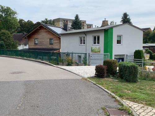 a house with a green and white at Ferienwohnung Herold in Olbernhau
