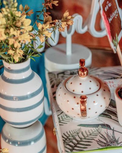 two white vases and a tea pot on a table at Villa Botanica in Mirkovec