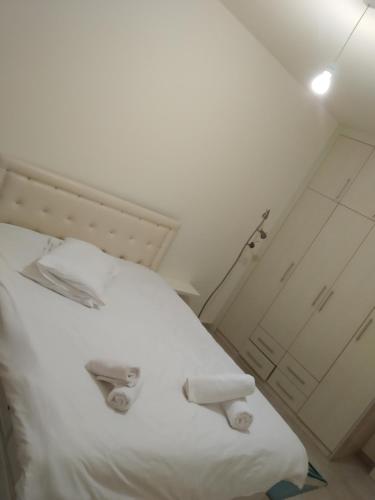 a white bed in a small room with a door at Sunrise Beach Club (Hera B6@) in Kalecik
