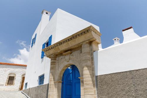a blue door on the side of a white building at House Salvia in Lachania
