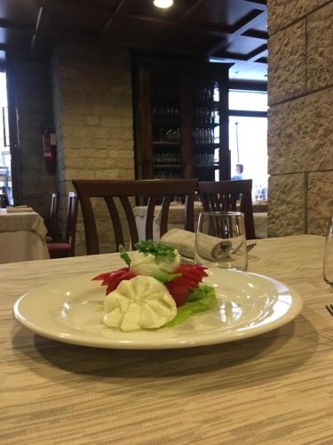 a plate of food sitting on a table at hotel dei consoli in Gubbio