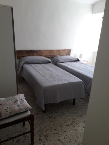 Un pat sau paturi într-o cameră la L'angolo fiorito