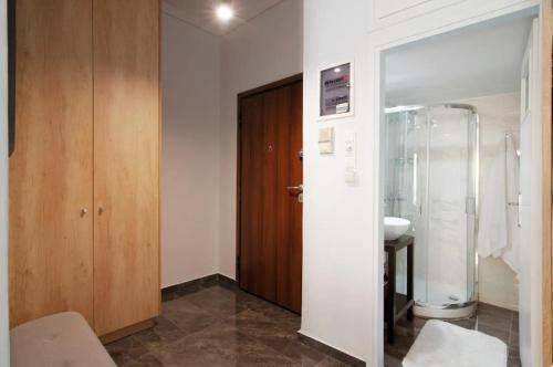 a bathroom with a shower and a toilet and a sink at Tiny Studio Suite in Athens