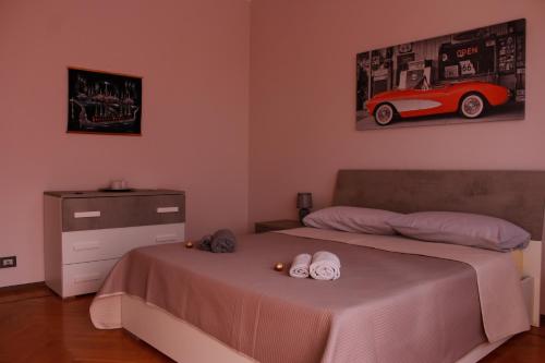 a bedroom with a bed and a red car on the wall at Giolitti Luxury Apartment in Cuneo