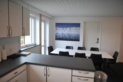 Una cocina con una mesa y sillas en una habitación. en Nuuk City Hostel, en Nuuk