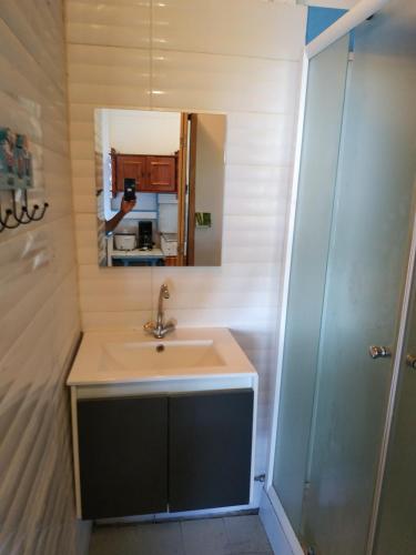 a bathroom with a sink and a mirror at Meryem in La Trinité