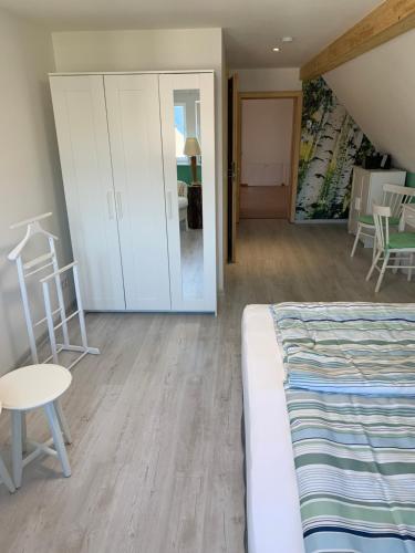 a bedroom with a bed and a table and chairs at FeWo Skiheim in Großschönau