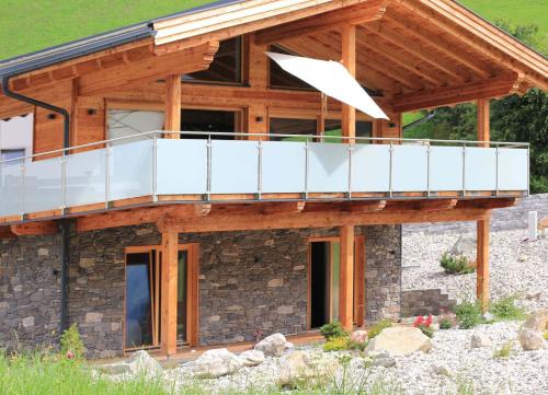 a house with a balcony on top of it at Mountain Chalet R in Berwang