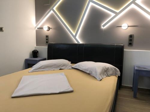 a bedroom with a bed with two pillows on it at M+V apartment in Alexandroupoli