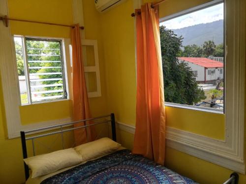 a bedroom with a bed and a window at Park Hostel in Port-au-Prince