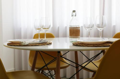 a table with two wine glasses and a bottle on it at COLD CITY HOUSE in Guarda