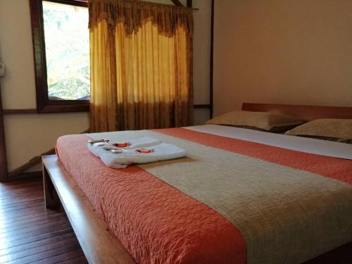 a hotel room with two beds with towels on the bed at Rio Napo Lodge in Puerto Misahuallí