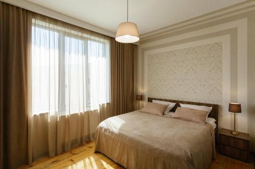 a bedroom with a bed and a large window at Brick walls in Gori