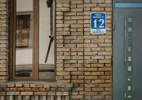 a sign on the side of a brick building at Brick walls in Gori