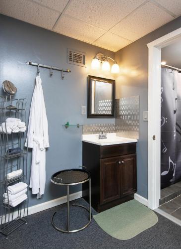 a bathroom with a sink and a counter and a stool at Music Valley Studio - No Stairs - Opryland Area in Nashville