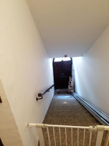 a stairway leading up to a black door at La Casa in Piazza in Gubbio