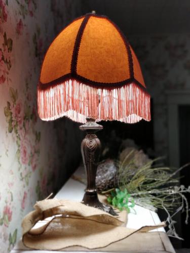 a lamp sitting on top of a table at The Lancaster Manor Bed and Breakfast in Gainesville