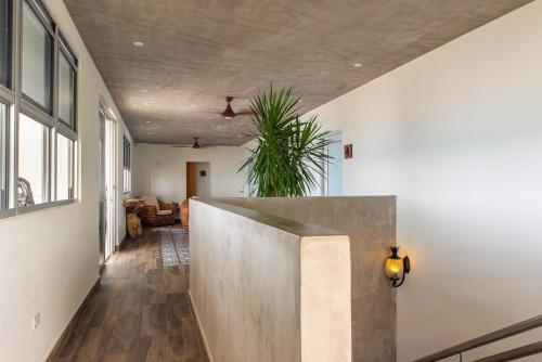 a hallway of a home with a concrete wall at Numero Uno Beach House in San Juan