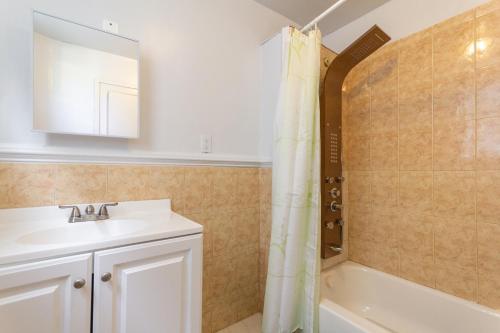 a bathroom with a sink and a bath tub at Entire House Belleville 4 Bedroom 2 Barh Parking NJ 8 in Belleville