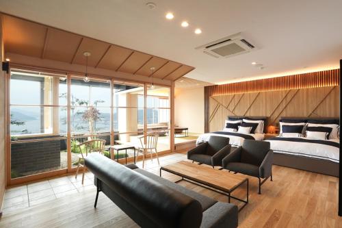 a bedroom with a bed and a couch and a table at Hotel Nagasaki in Nagasaki
