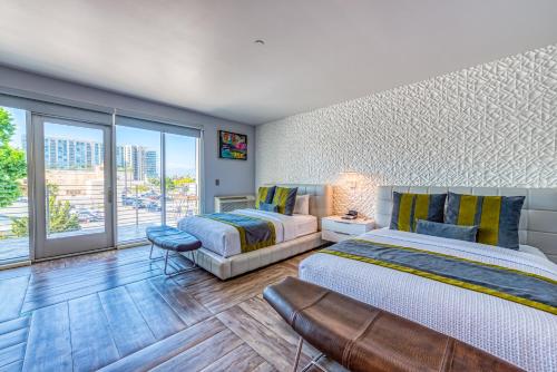 a bedroom with two beds and a large window at Lexen Hotel - North Hollywood Near Universal Studios in North Hollywood