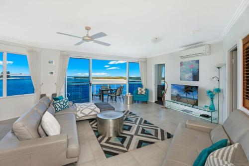 a living room with a couch and a table at Watermark Resort Caloundra in Caloundra