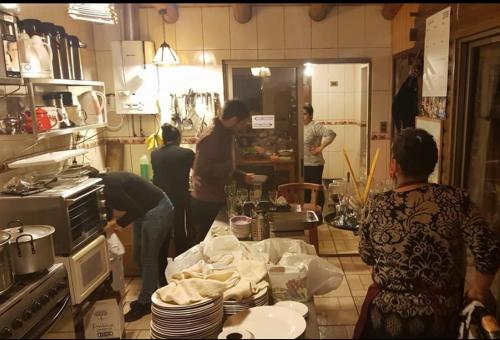 a group of people in a kitchen preparing food at Cabañas Rukas Licantén in Licantén