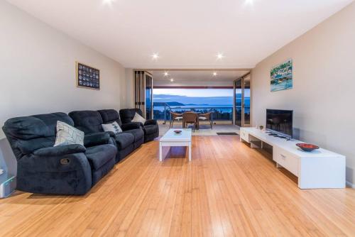 a living room with a couch and a table at Getaway Ocean Views in Airlie Beach