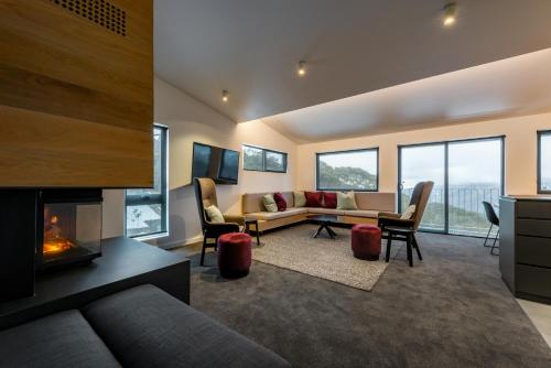 a living room with a couch and a fireplace at Elk at Falls in Falls Creek