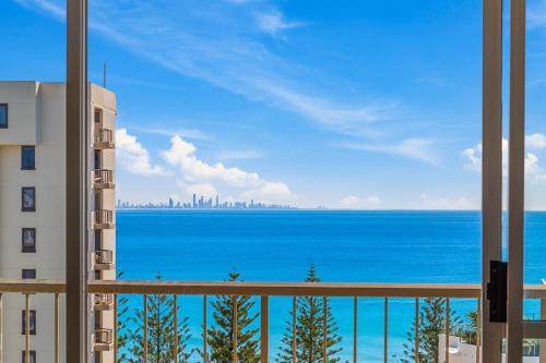 
a view from the balcony of a large building at Rainbow Commodore Apartments in Gold Coast
