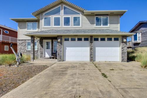 a house with two garage doors on a driveway at Beauty and the Beach in Waldport